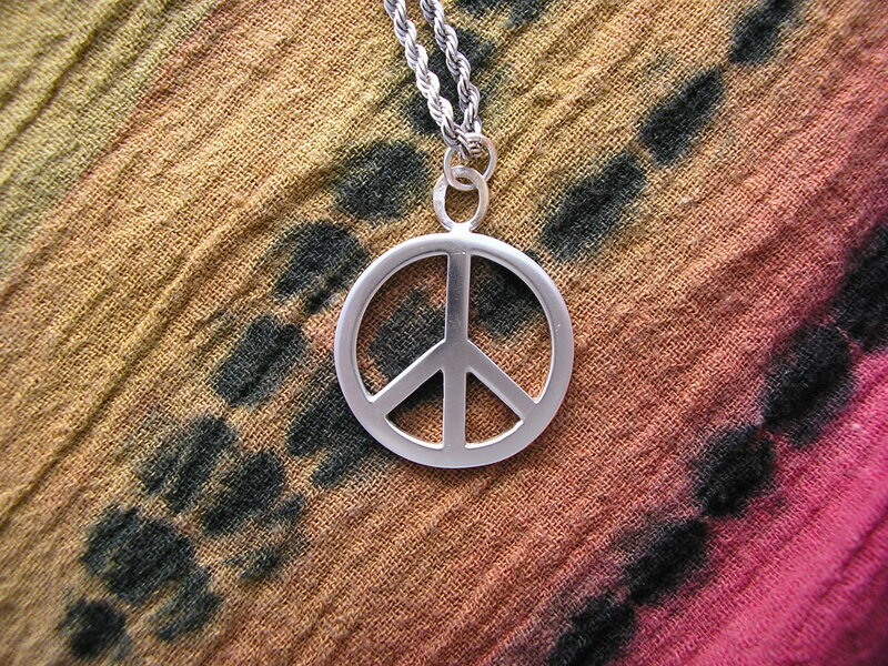 Peace symbol pendant on fabric