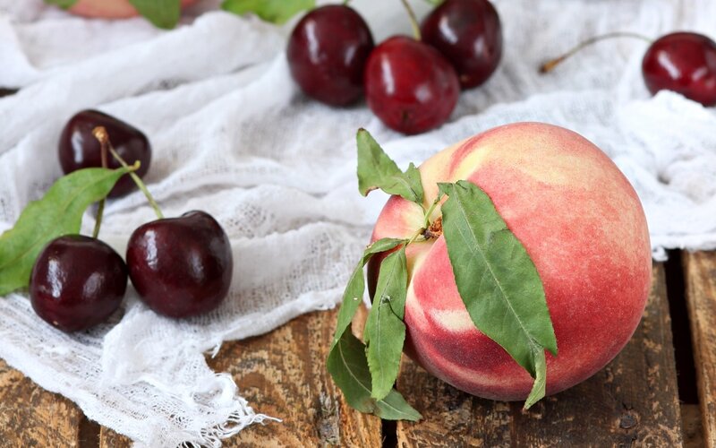 peach and cherries on cloth
