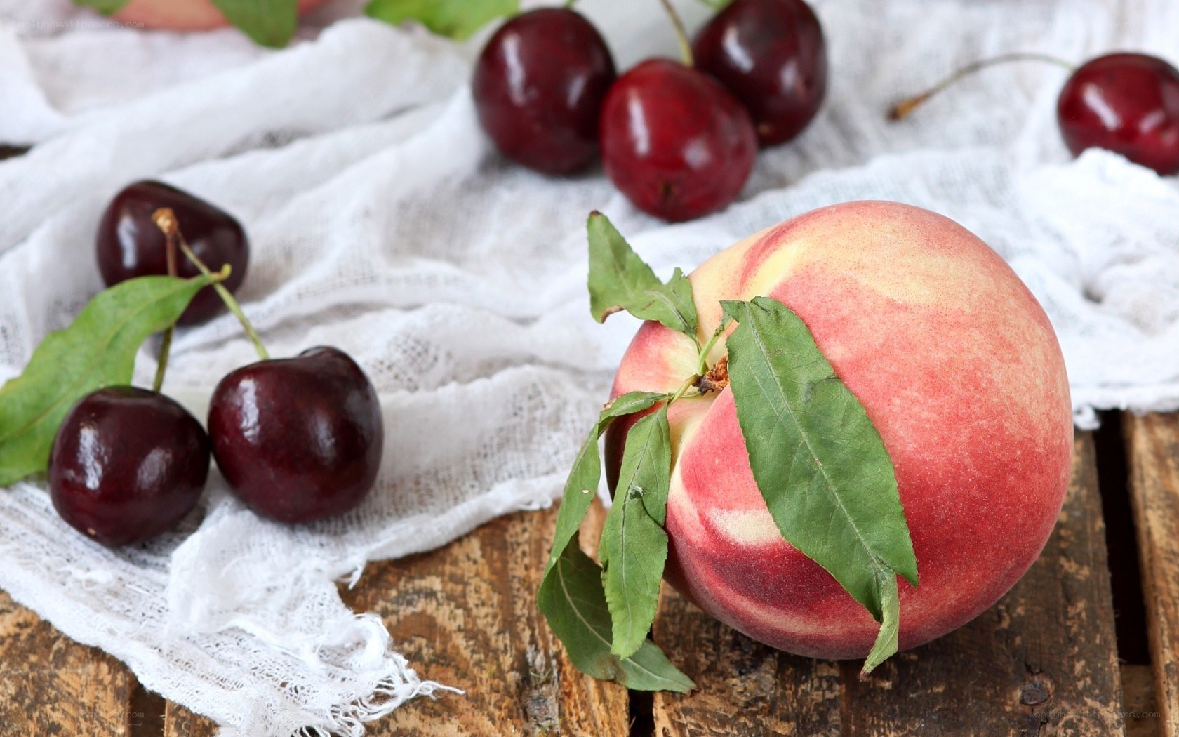 peach and cherries on cloth