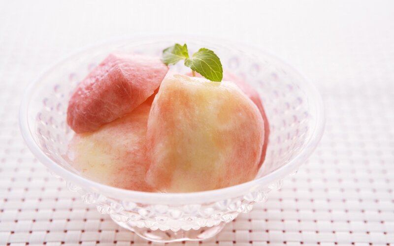 peach dessert in glass bowl