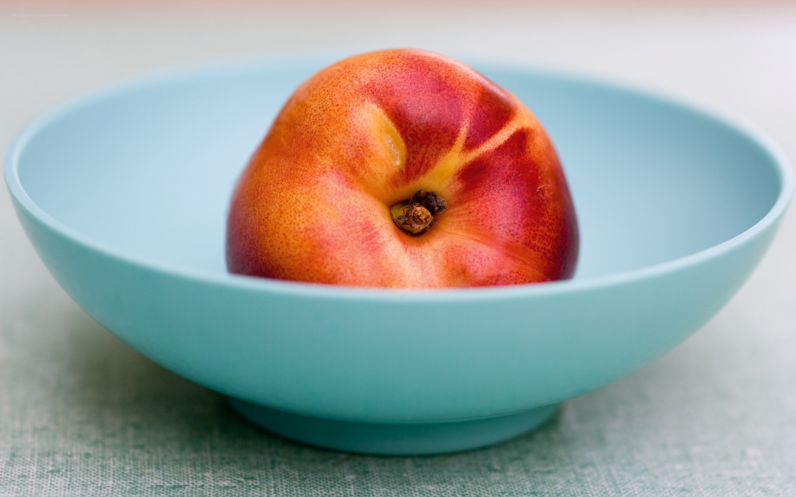 peach in a blue bowl