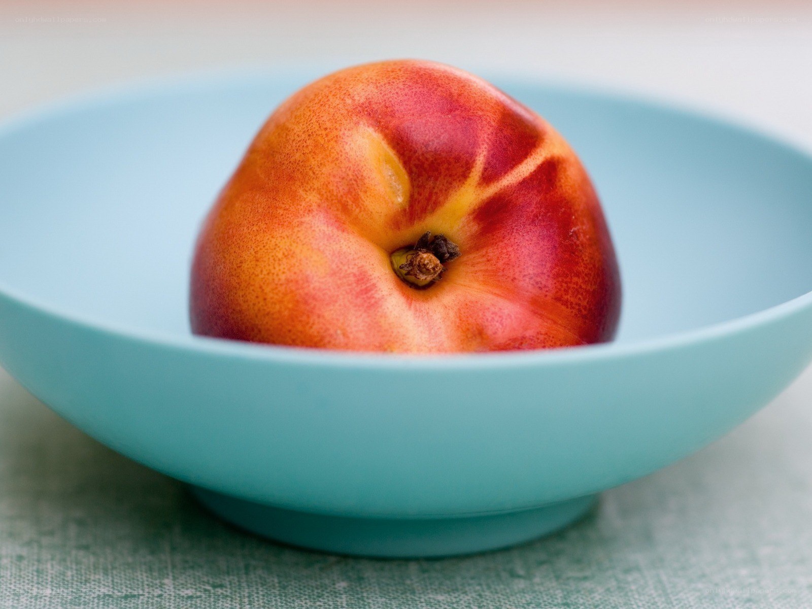peach in a blue bowl