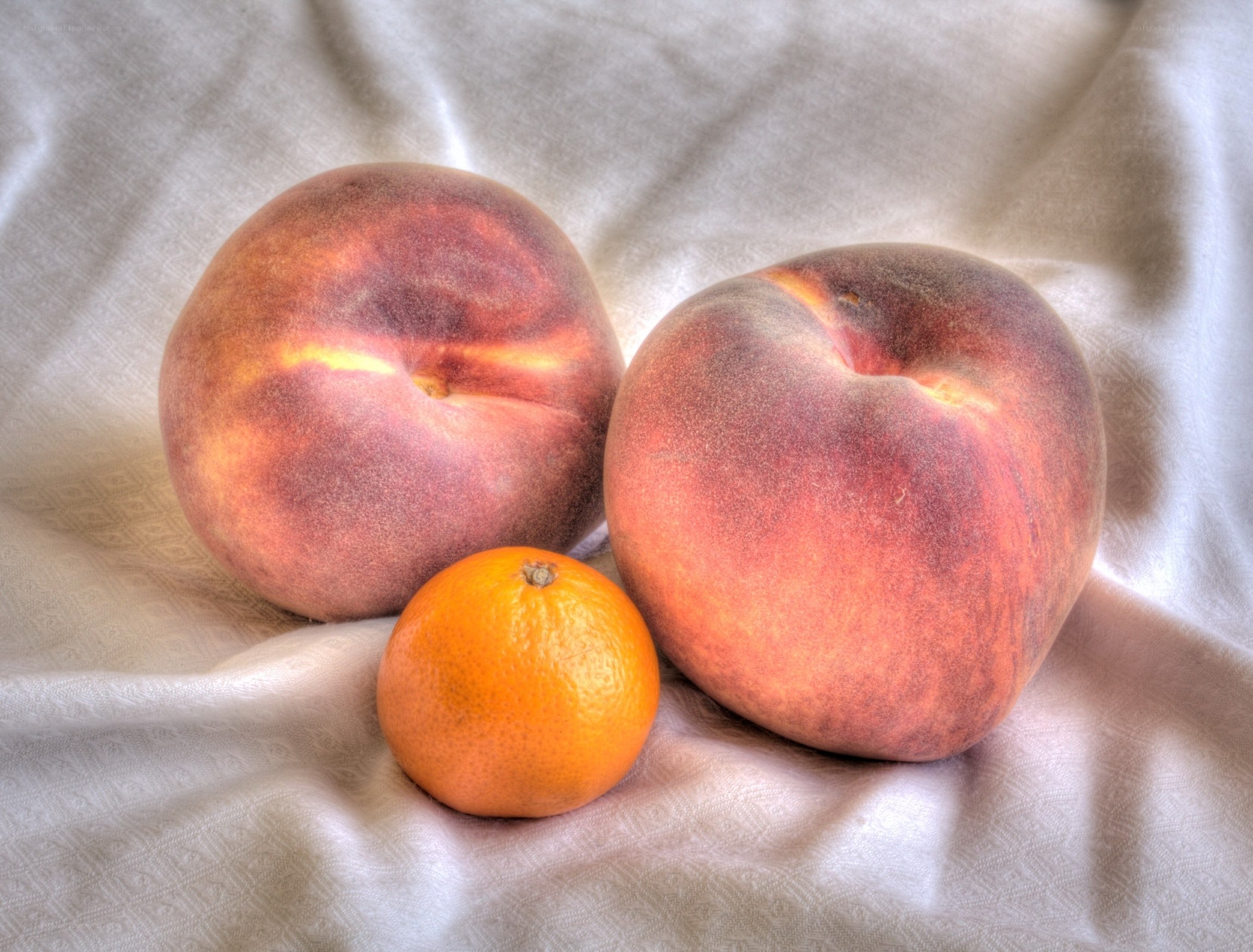 peaches and tangerine on cloth
