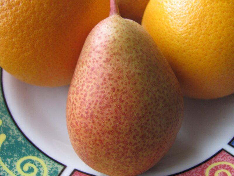 pear and oranges on a plate