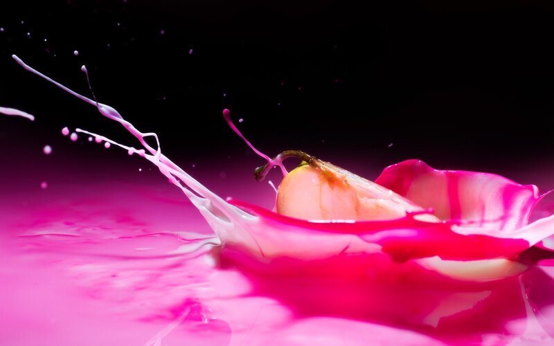 pear splashing in pink liquid