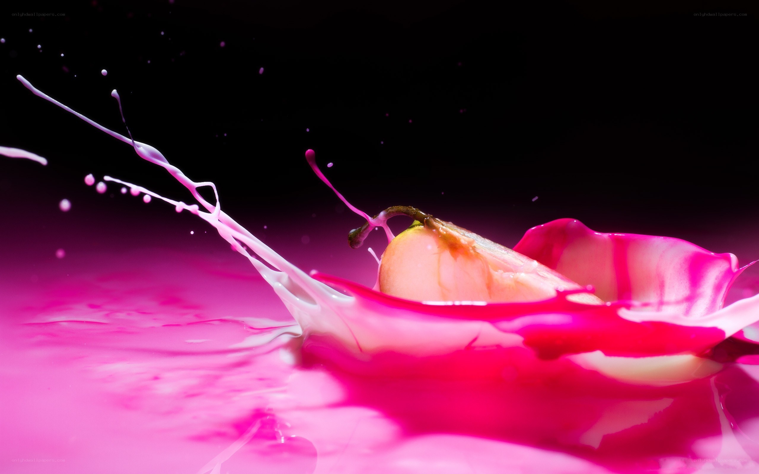 pear splashing in pink liquid