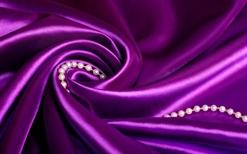 Pearl Necklace on Purple Fabric