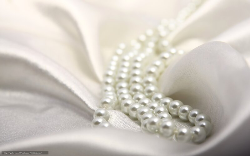 pearl necklace on white fabric