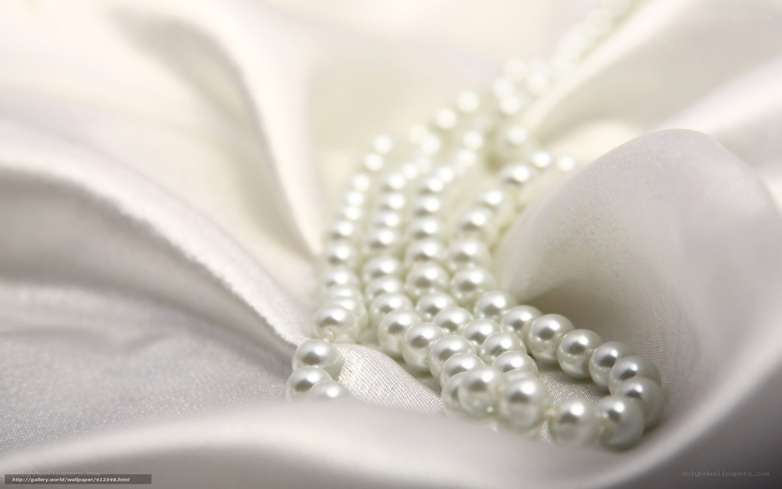pearl necklace on white fabric