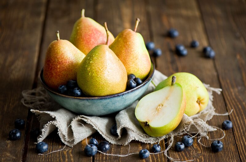 Pears and blueberries on wood