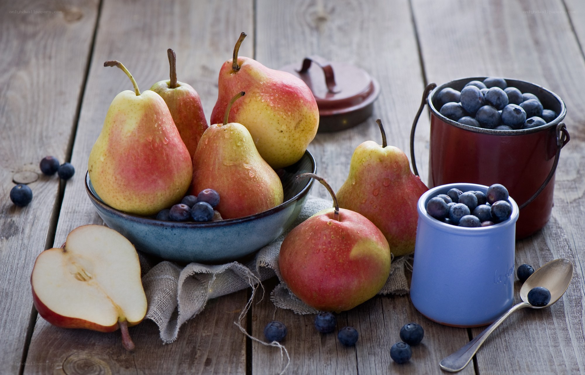 Pears and blueberries on wood