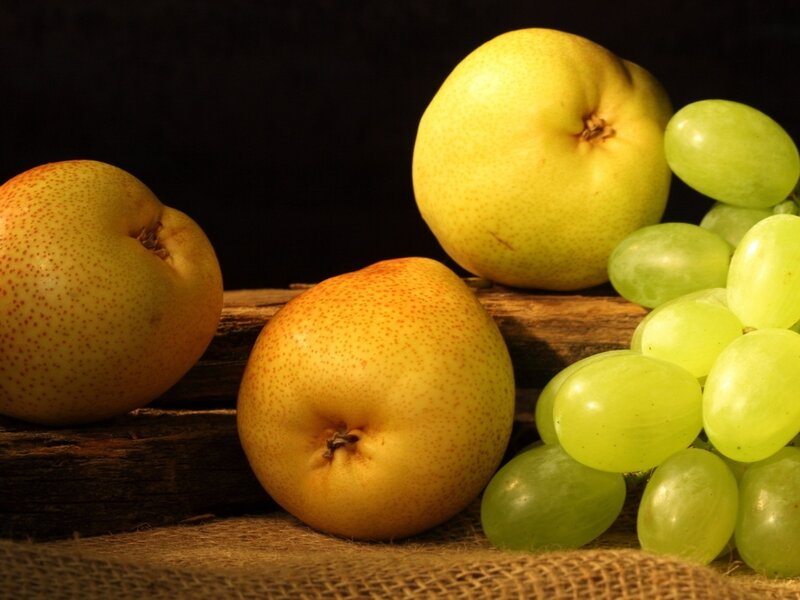 Pears and grapes on wood