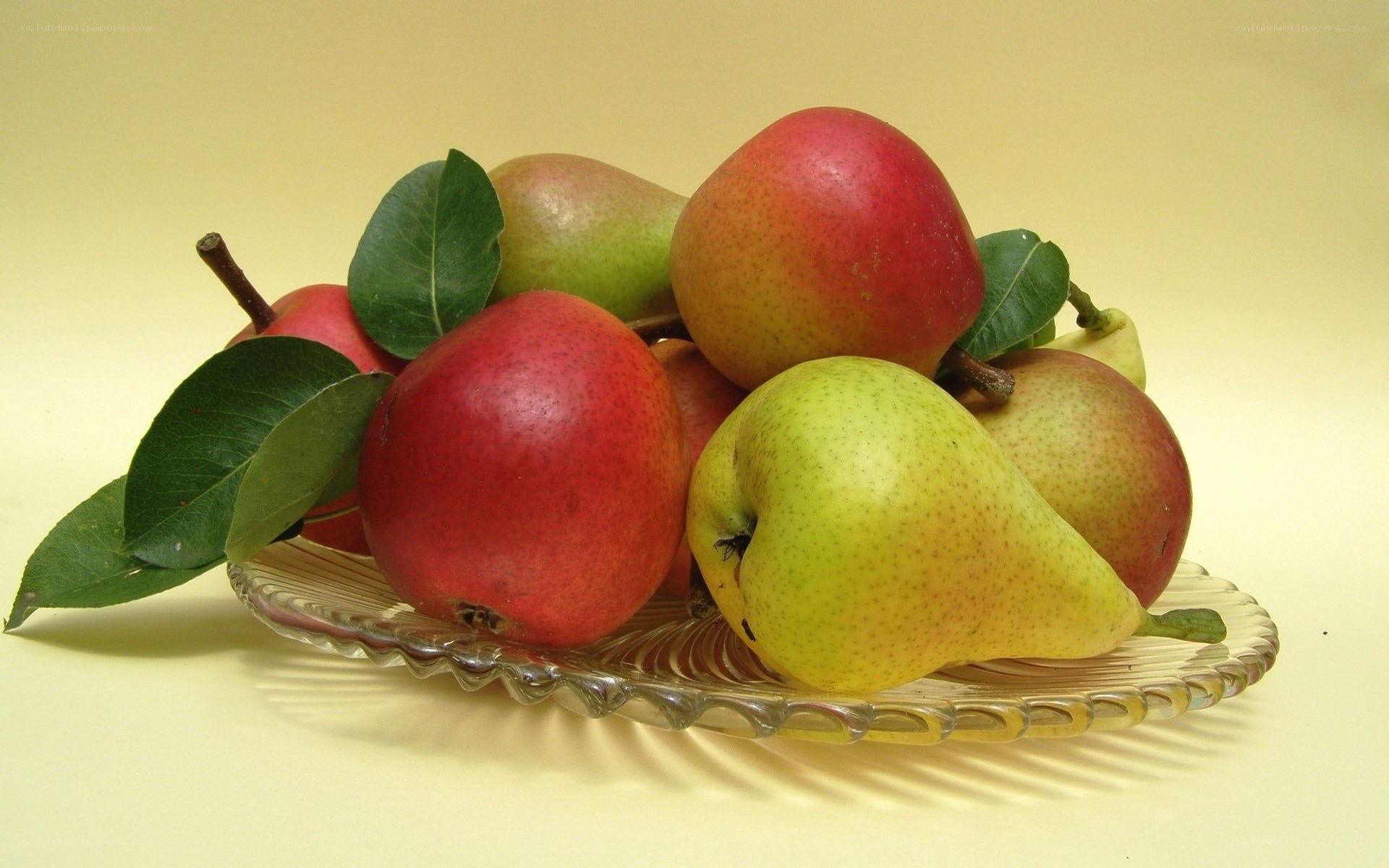 Pears with leaves on a glass plate