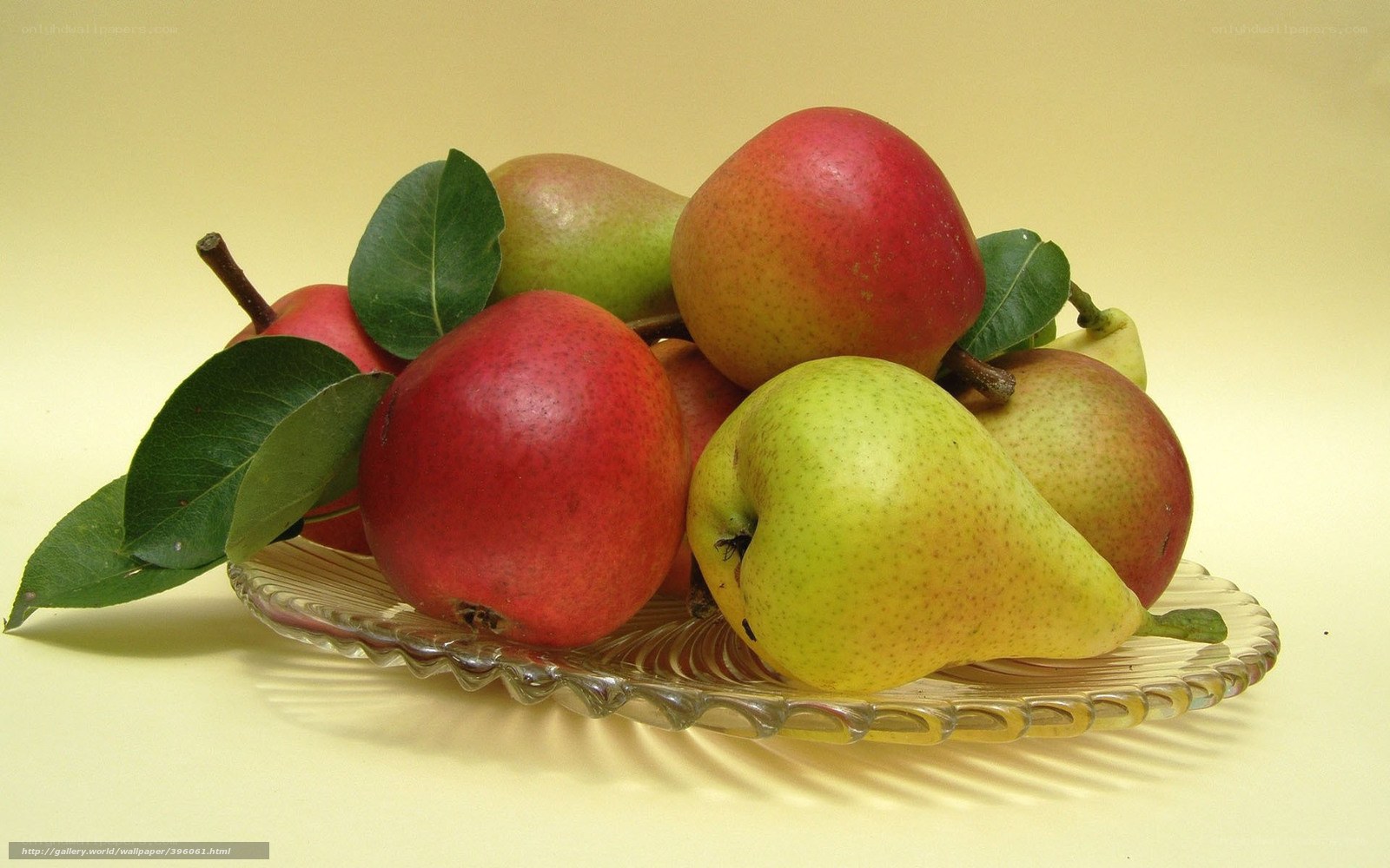 Pears with leaves on glass plate