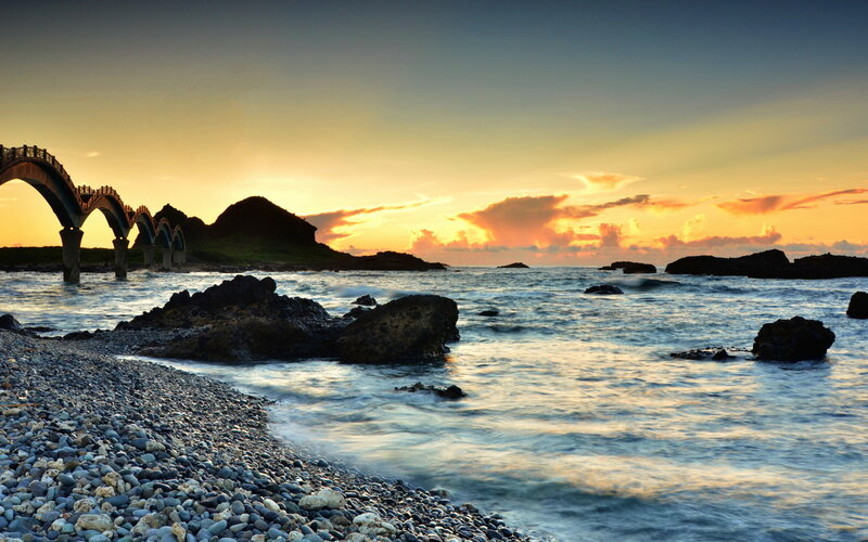 Pebble Beach at Sunset — Orange, Serene, Photograph, Bridge