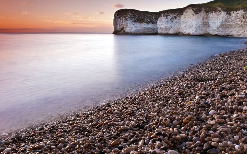 Pebble Beach at Sunset — Orange, Serene, Photograph, Cliffs, Sea