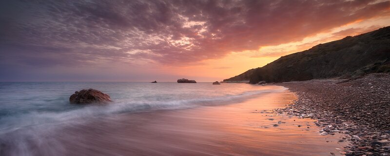 Pebble Beach at Sunset — Orange, Serene, Photograph, Ocean, Rocks, Cliff, Purple