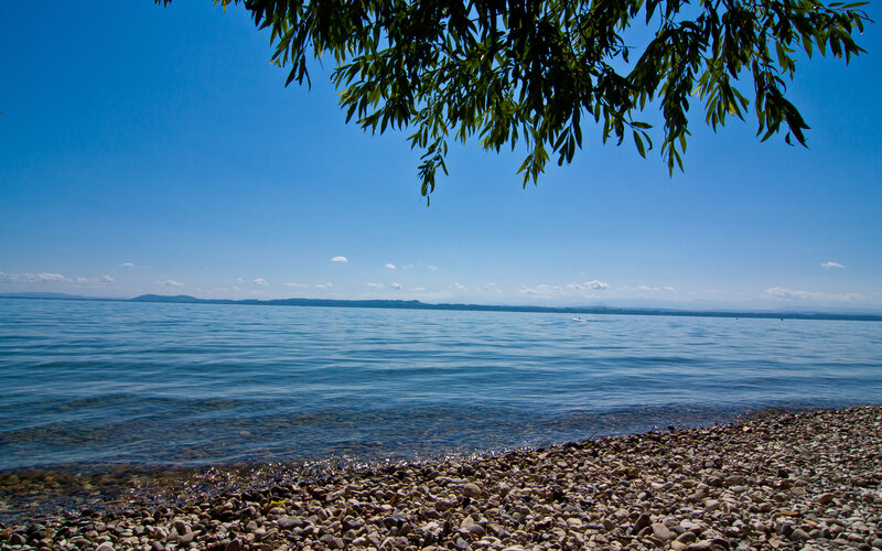 Pebble beach by a calm lake