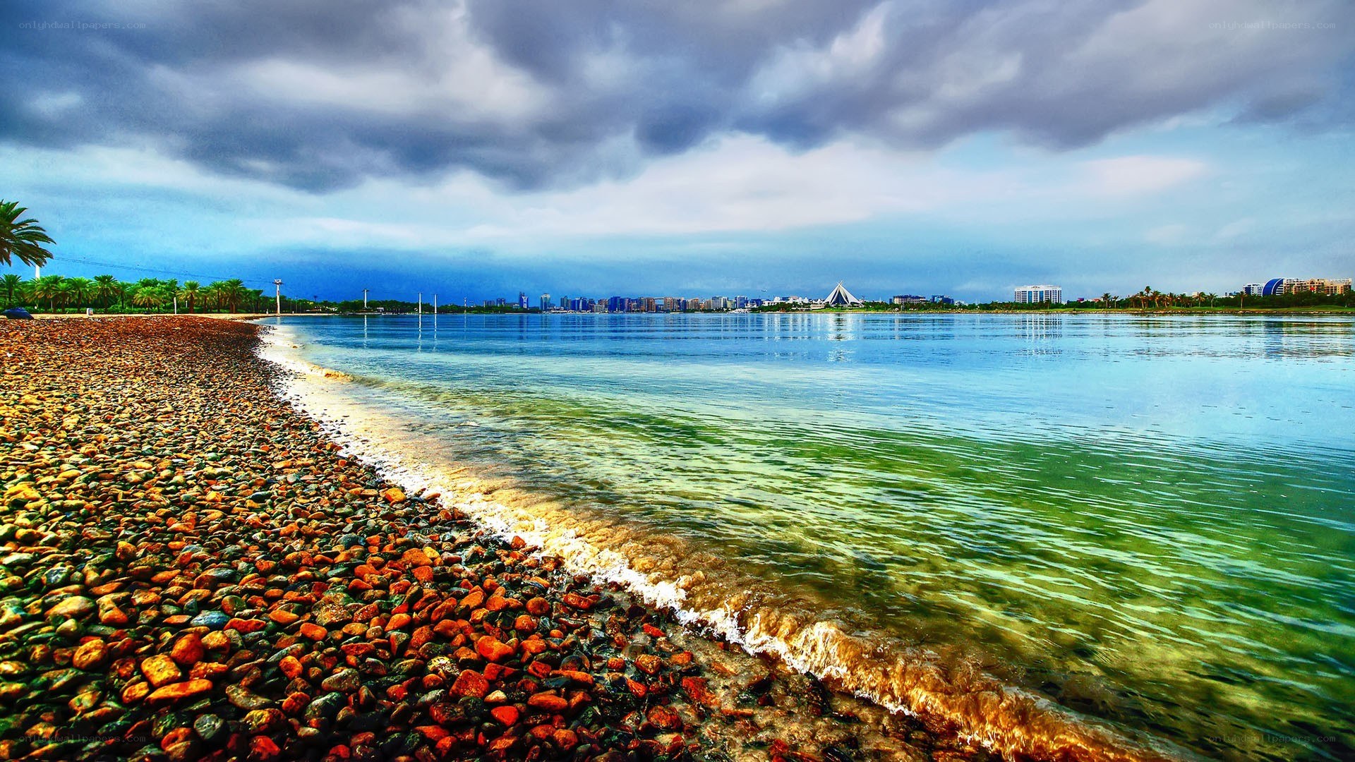 Pebble beach with city skyline