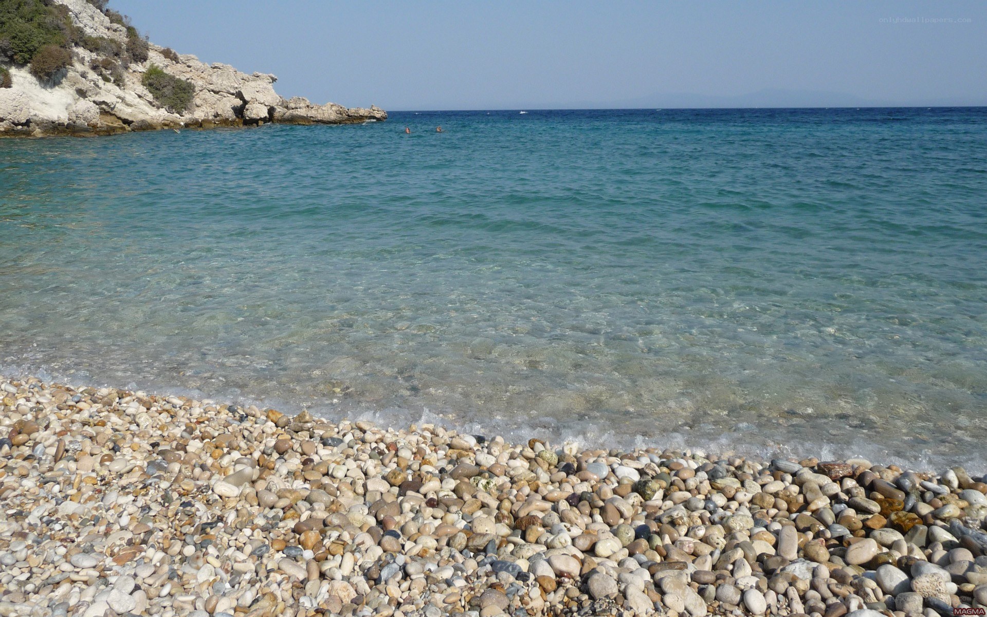 pebble beach with clear water