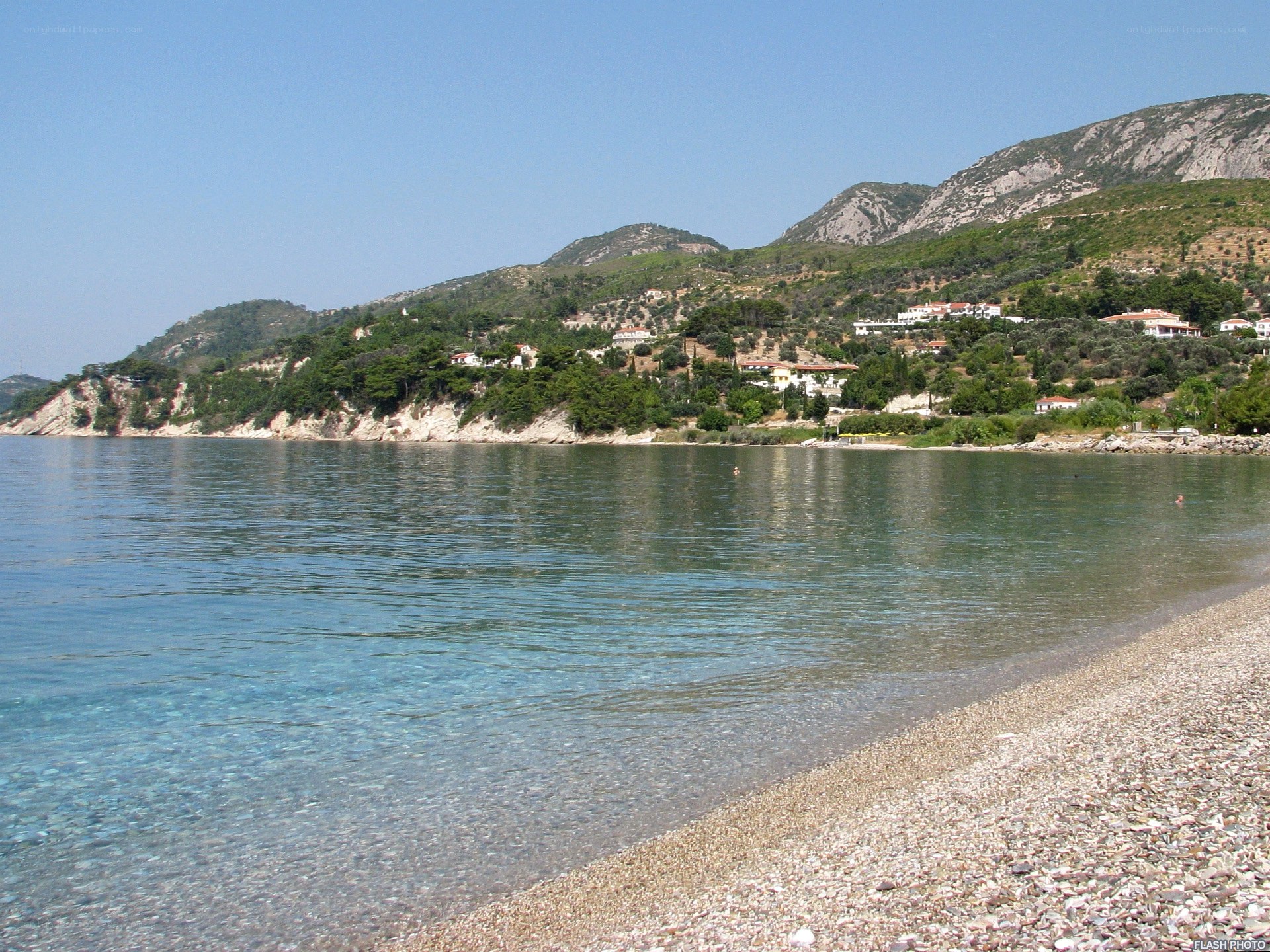 pebble beach with coastal village