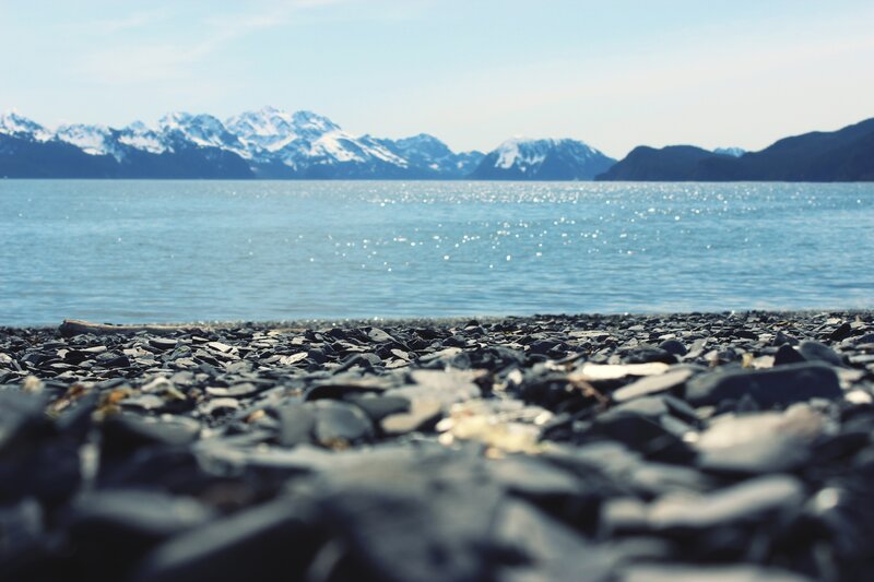 pebble beach with mountains