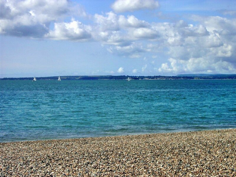 Pebble Beach with Sailboats