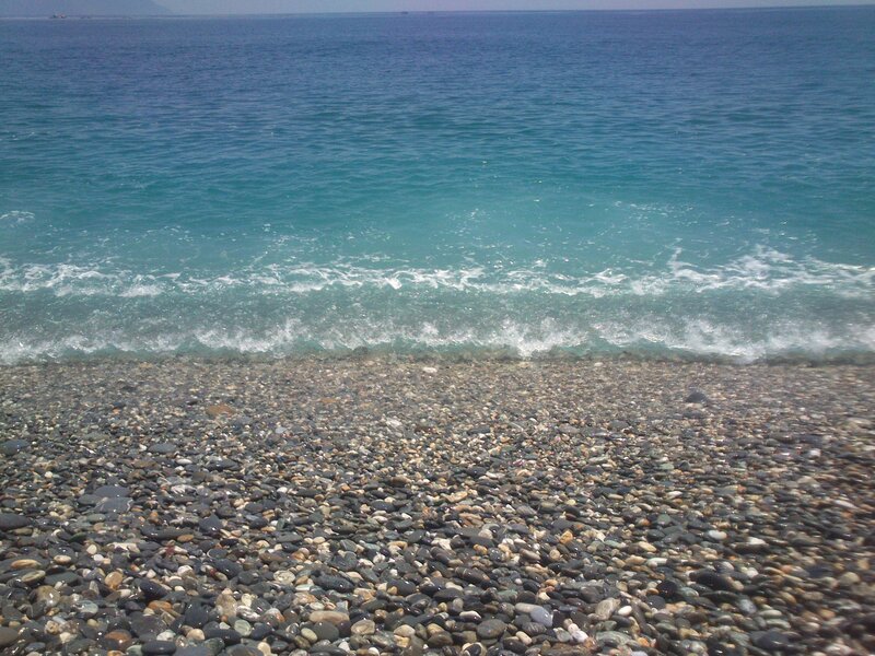 pebble beach with turquoise waves