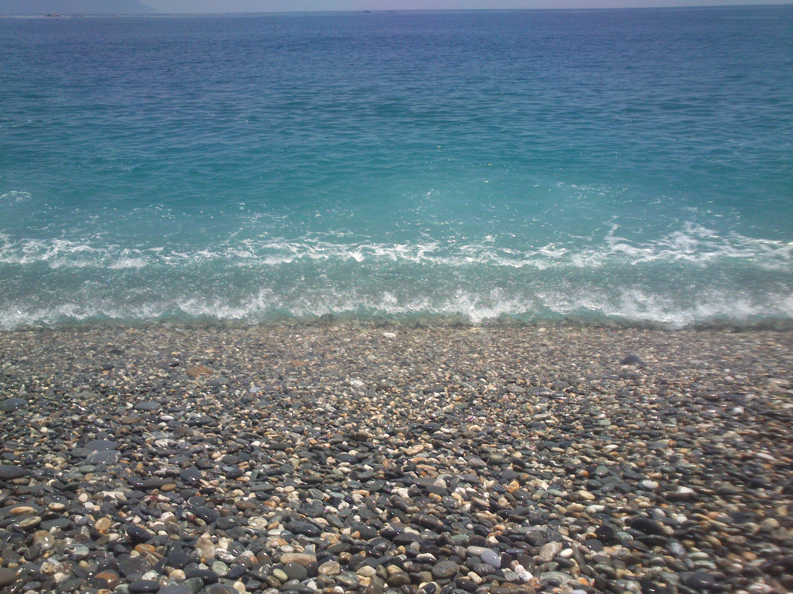pebble beach with turquoise waves
