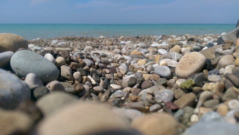 Pebbles on Beach — Blue, Calm, Afternoon