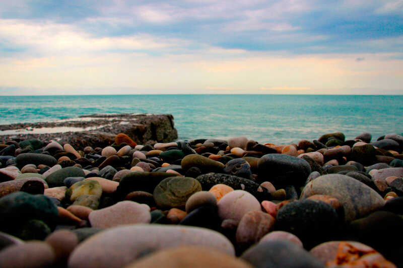 Pebbles on Beach — Blue, Serene, Sunset