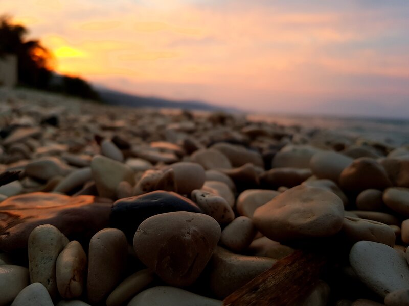 Pebbles on Beach — Orange, Serene, Sunset
