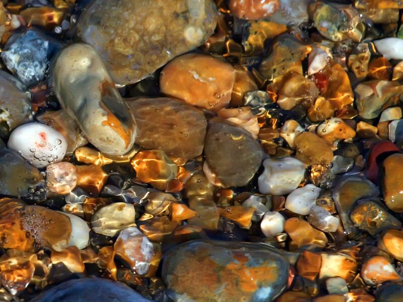 pebbles under clear water