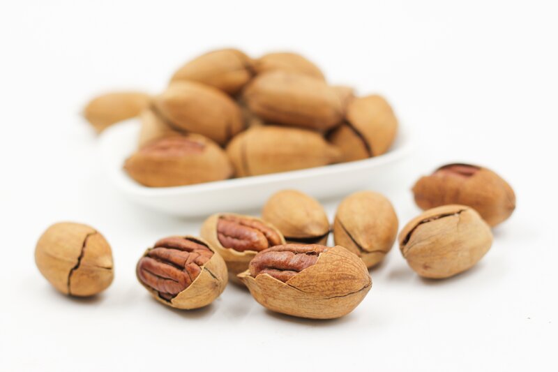 pecan nuts on white surface
