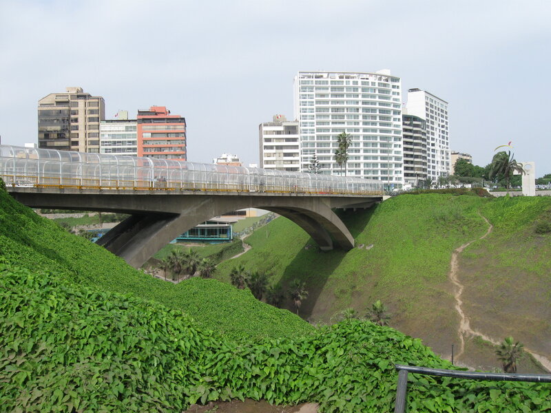 Pedestrian bridge over green hills