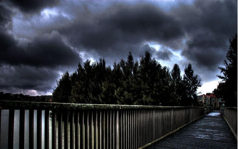 Pedestrian Bridge under Storm Clouds