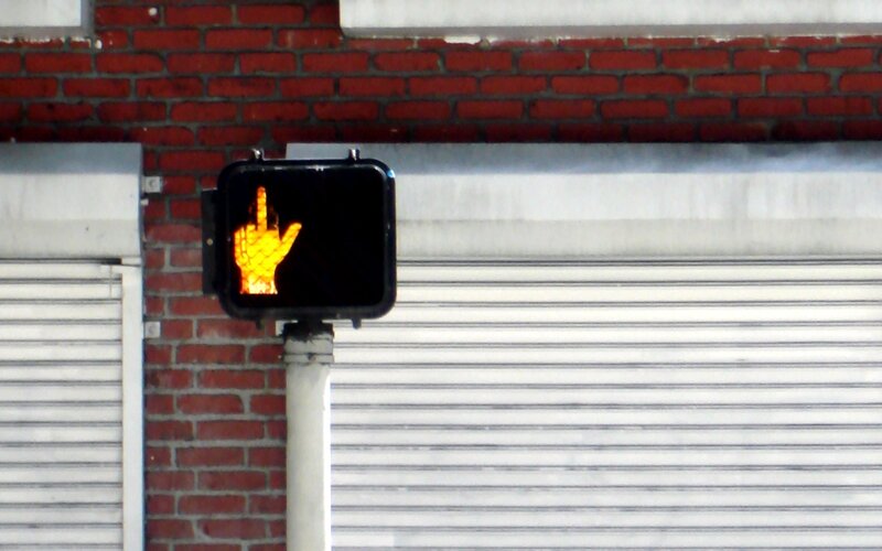 Pedestrian crossing signal with middle finger