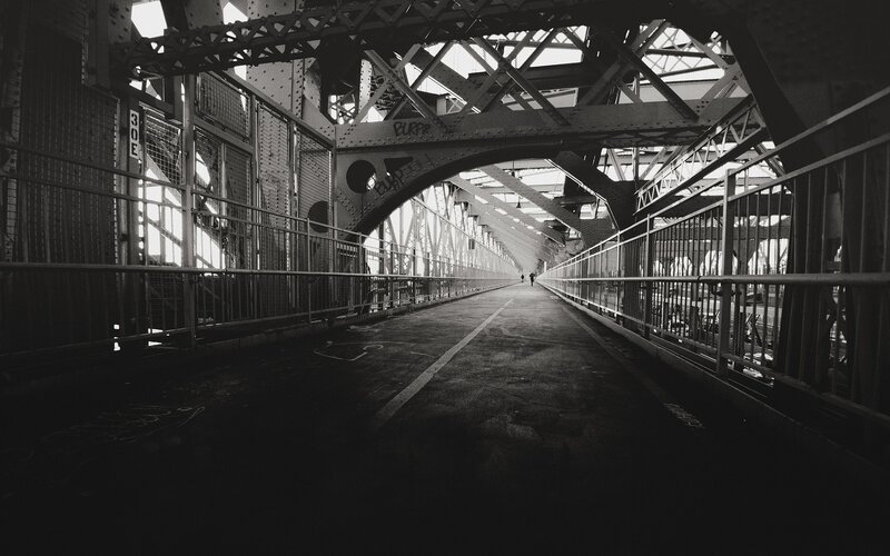 Pedestrian walkway under a steel bridge