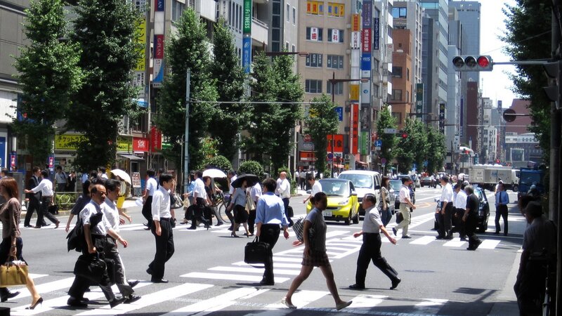 Pedestrians crossing a busy street in Tokyo