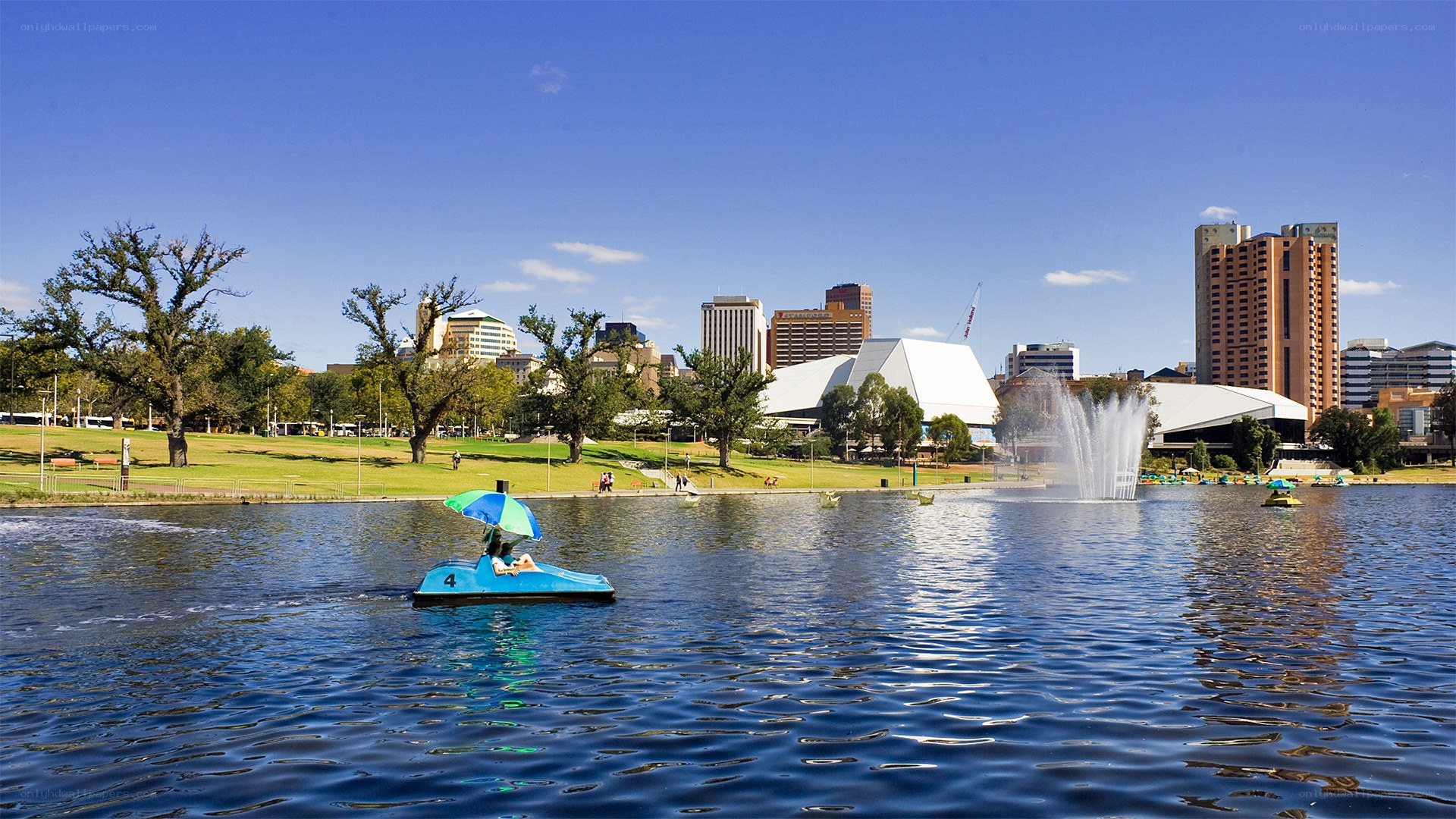 Pedicab on lake with city skyline
