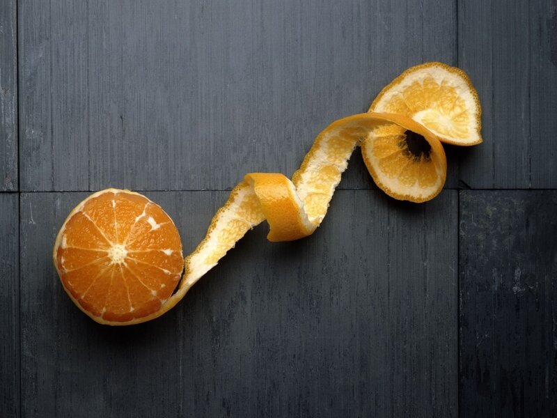 peeled orange on dark wood