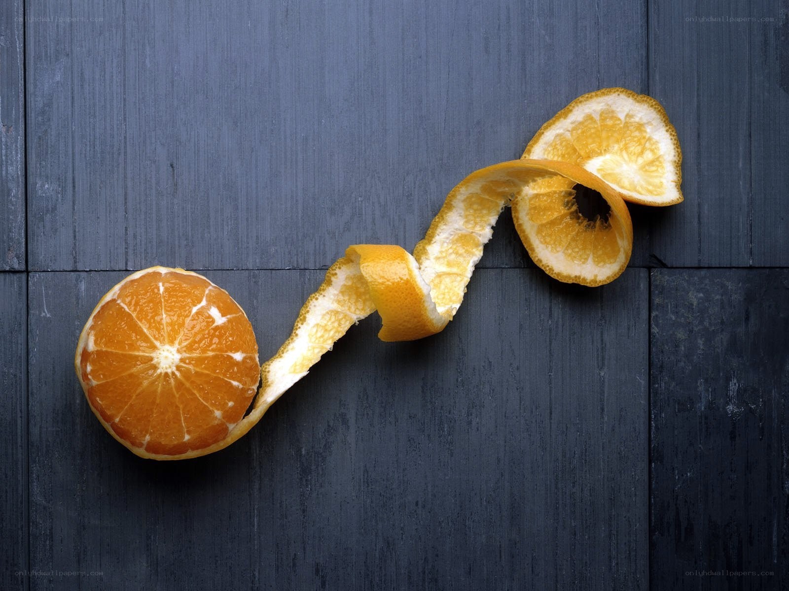 peeled orange on dark wood