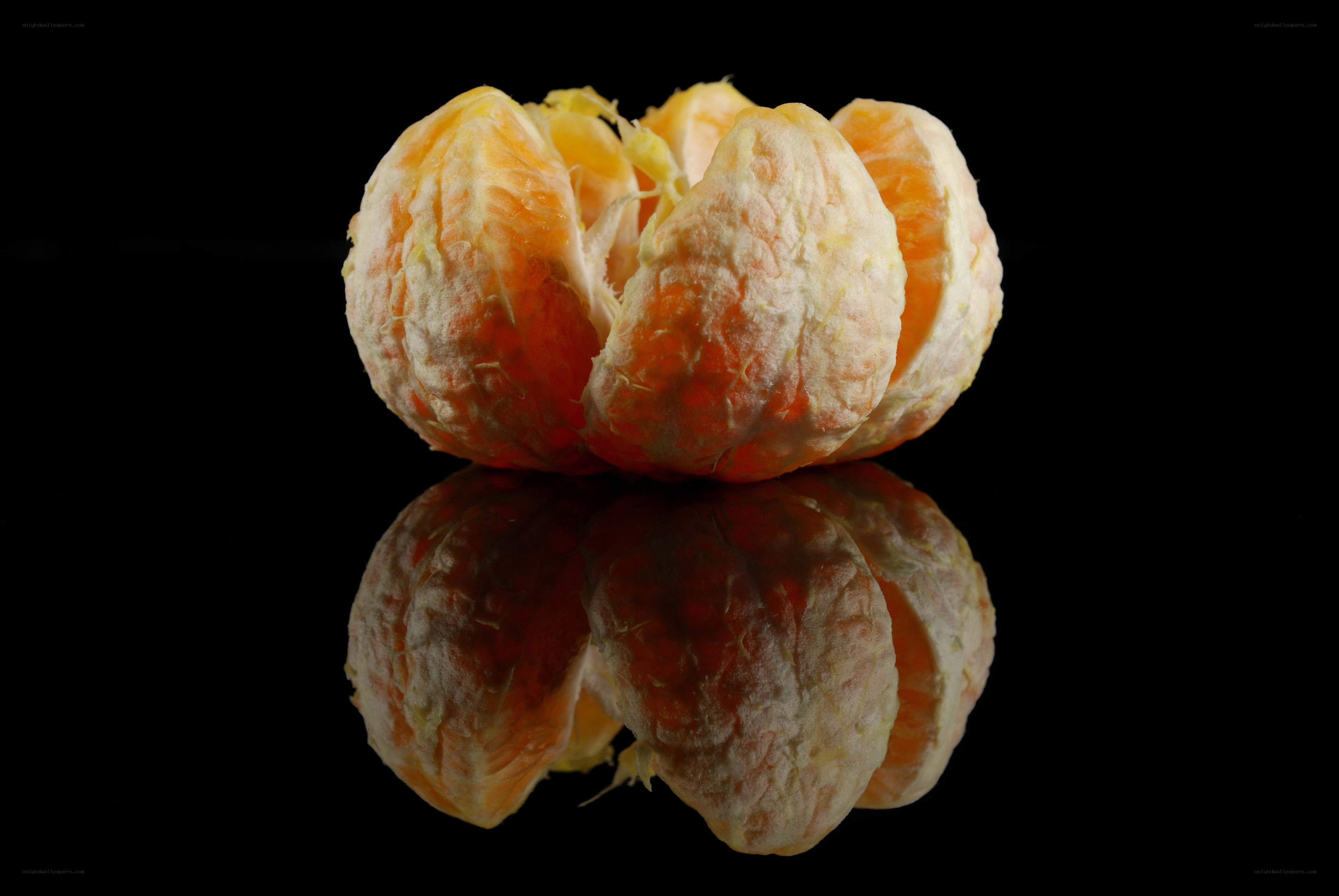 peeled tangerine on black