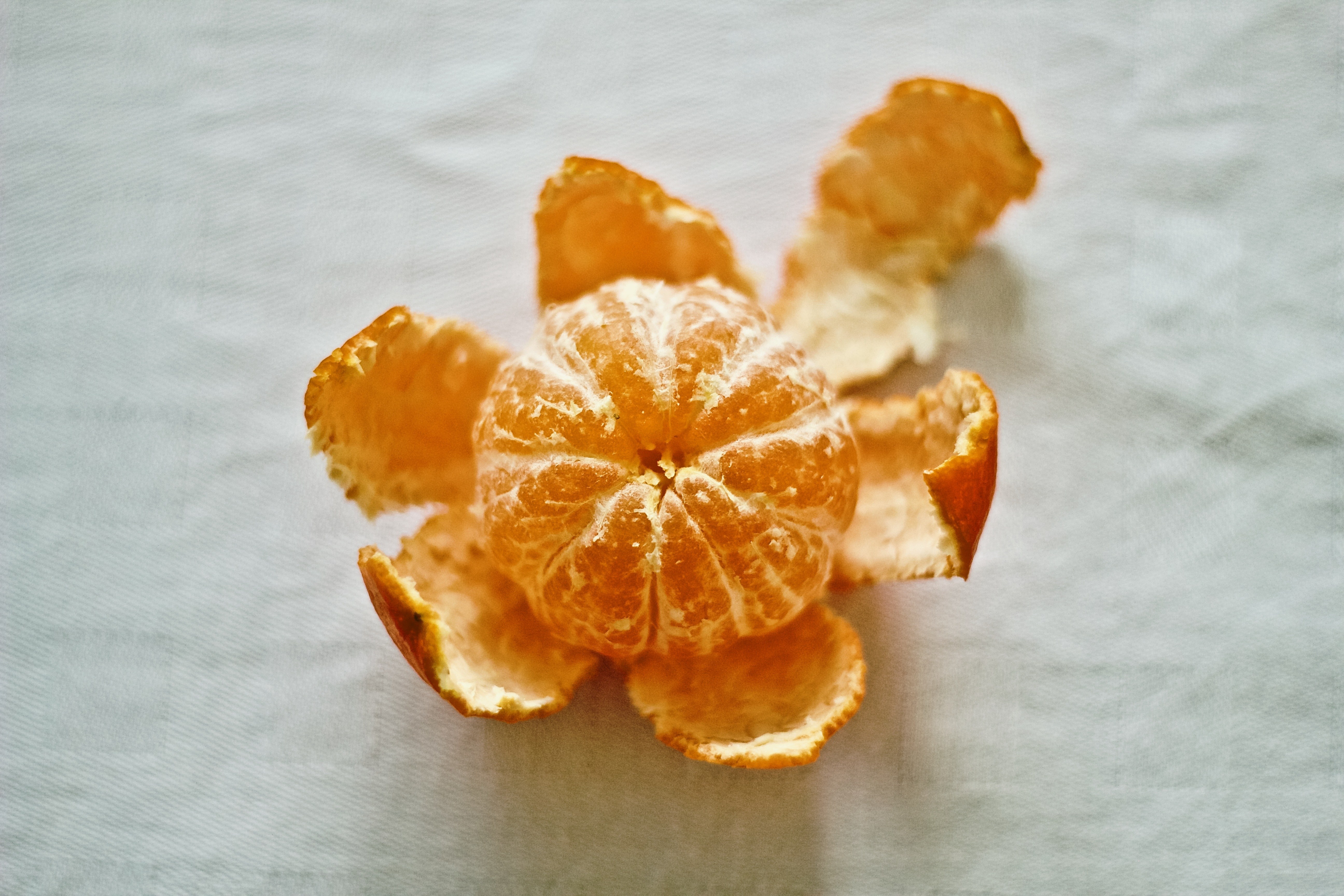 peeled tangerine on cloth