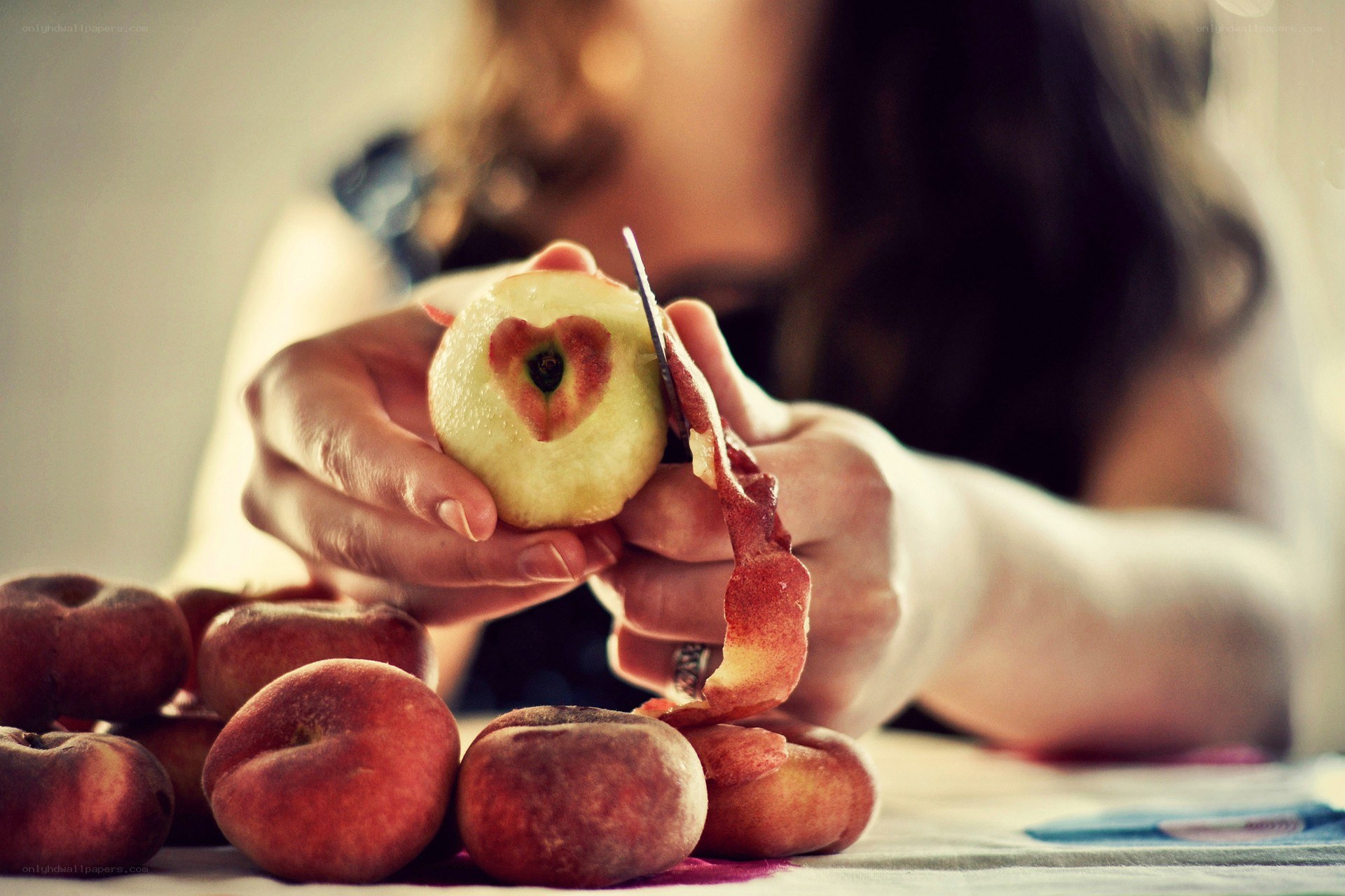 peeling an apple with a heart
