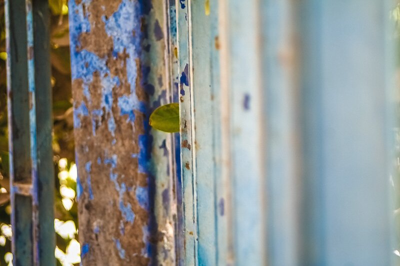peeling blue paint on metal bars