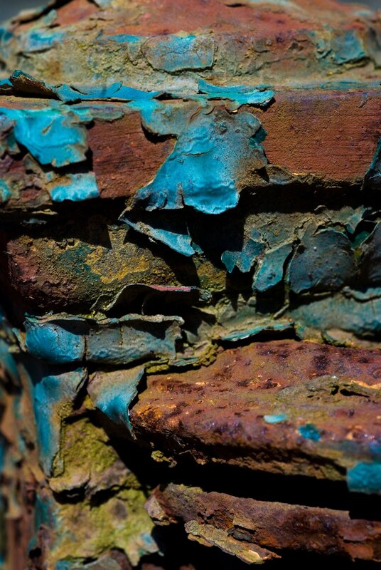 peeling blue paint on rusted metal