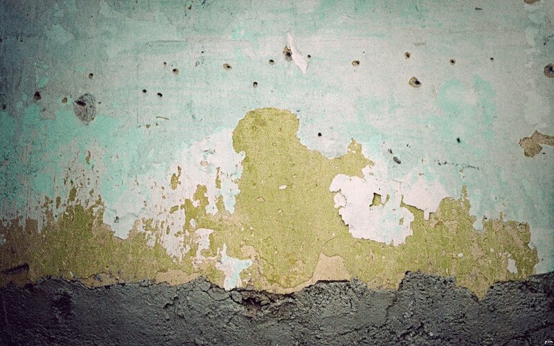 peeling paint on a weathered wall