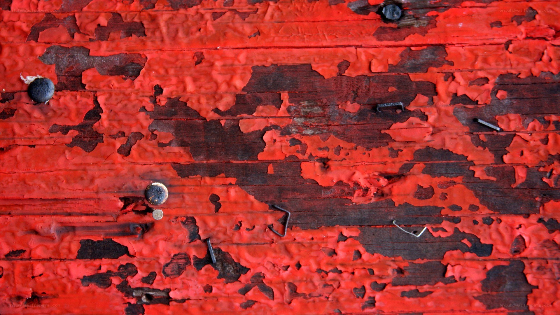 peeling red paint on wood
