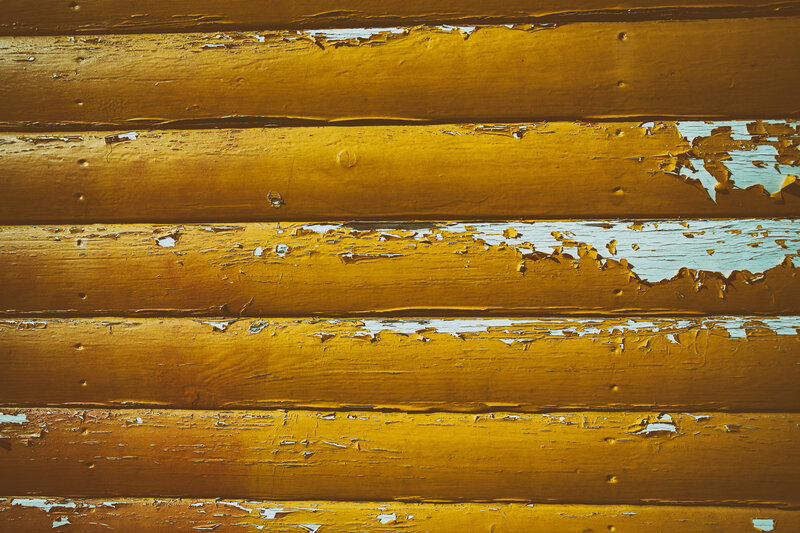 peeling yellow paint on wood
